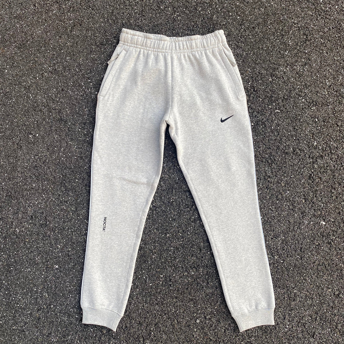 Pantaloni Nike x Nocta grigi