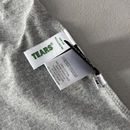 Maglietta con lacrime di denim 